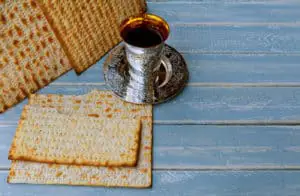 Jewish holiday, Holiday symbol passover matzo with kiddush cup of wine on wooden table